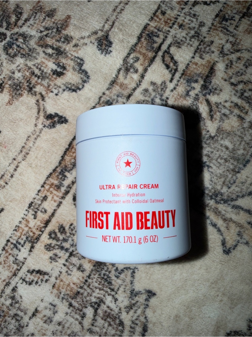 First Aid Beauty Moisturizer Jar in White with Red Logo